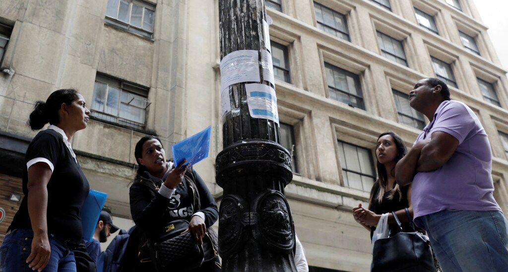 People look at lists of job openings posted on a street in downtown Sao Paulo, Brazil January 9, 2018. REUTERS/Paulo Whitaker - RC1D53A08340