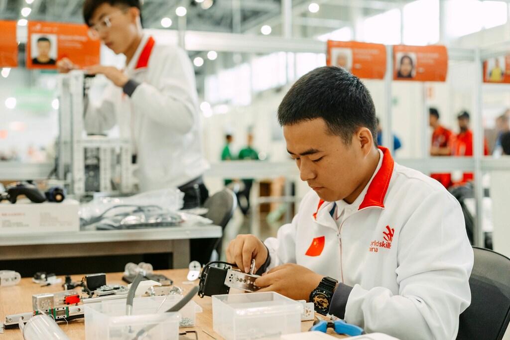 A young Chinese person working with robotics at the WorldSkills Competition in Kazan, Russia, in 2019