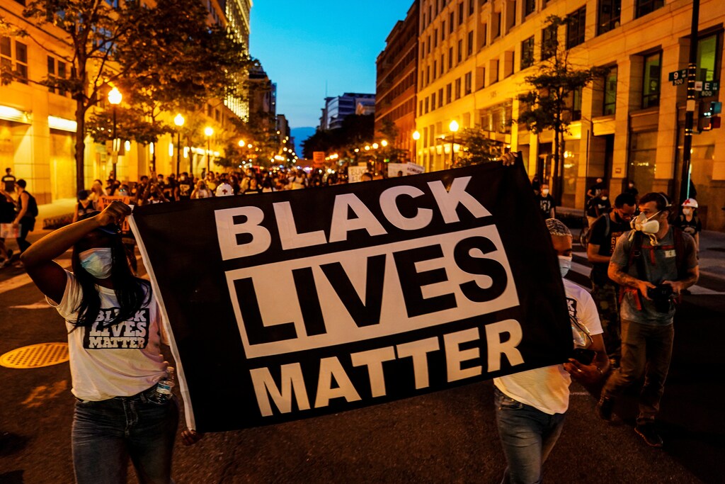 People hold up a Black Lives Matter banner as they march during a demonstration against racial inequality in the aftermath of the death in Minneapolis police custody of George Floyd, in Washington, U.S., June 14, 2020. REUTERS/Erin Scott - RC2D9H9RAS3Z