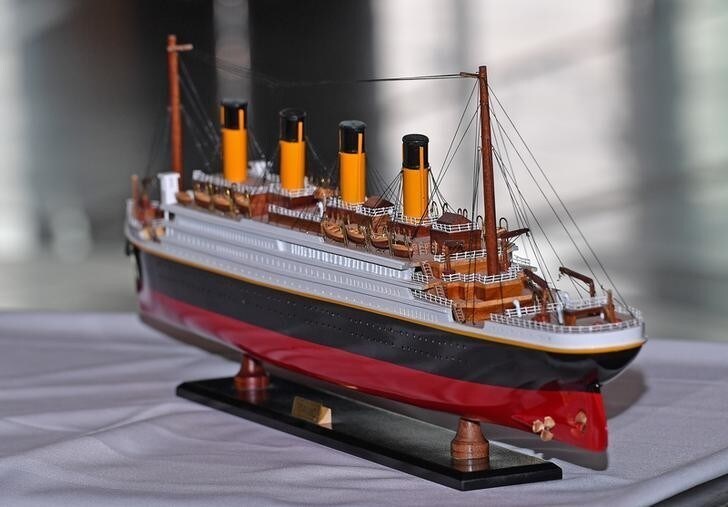 A model of the Titanic is presented to Prince Harry and Meghan Markle during their visit to Titanic Belfast maritime museum in Belfast, Northern Ireland March 23, 2018. Joe Giddens/Pool via REUTERS
