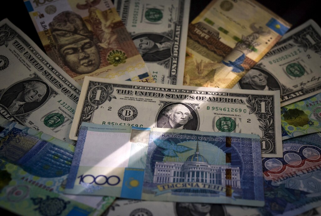 A picture illustration shows Kazakhstan's tenge and U.S. dollars banknotes in Almaty, Kazakhstan, August 21, 2015. Kazakhstanis took to social media on Friday to mock and grumble as vendors hiked their prices after veteran leader Nursultan Nazarbayev let the tenge currency join a global wave of devaluations.The tenge rate tumbled by 26.2 percent on Thursday to 255.26 per dollar as the central bank and government decided to let it float freely, seeking to support an economy hit by low world prices for its oil and metals exports. REUTERS/Shamil Zhumatov - GF10000178567