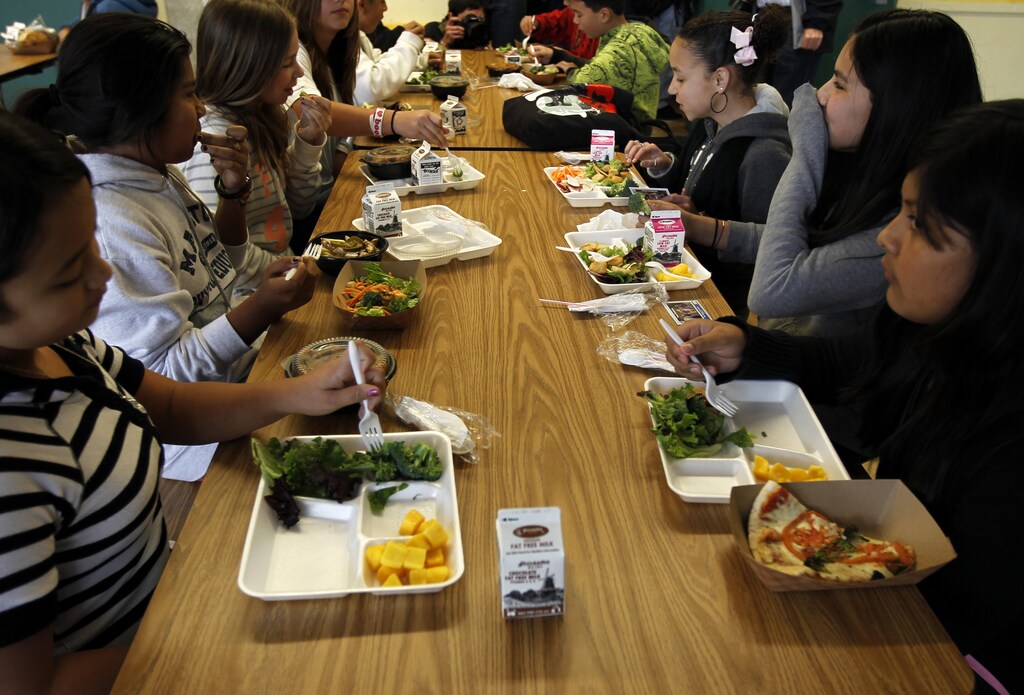 Students sit down to eat a healthy lunch at Marston Middle School in San Diego, California, March 7, 2011.