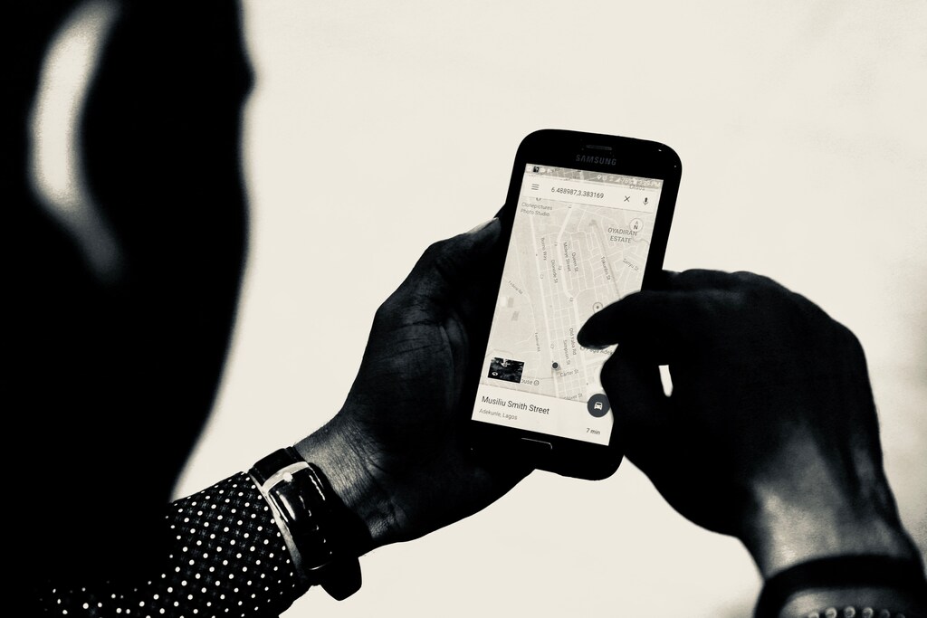 person using Google map maps digital technology artificial intelligence navigation navigate direction north south east west co-ordinates