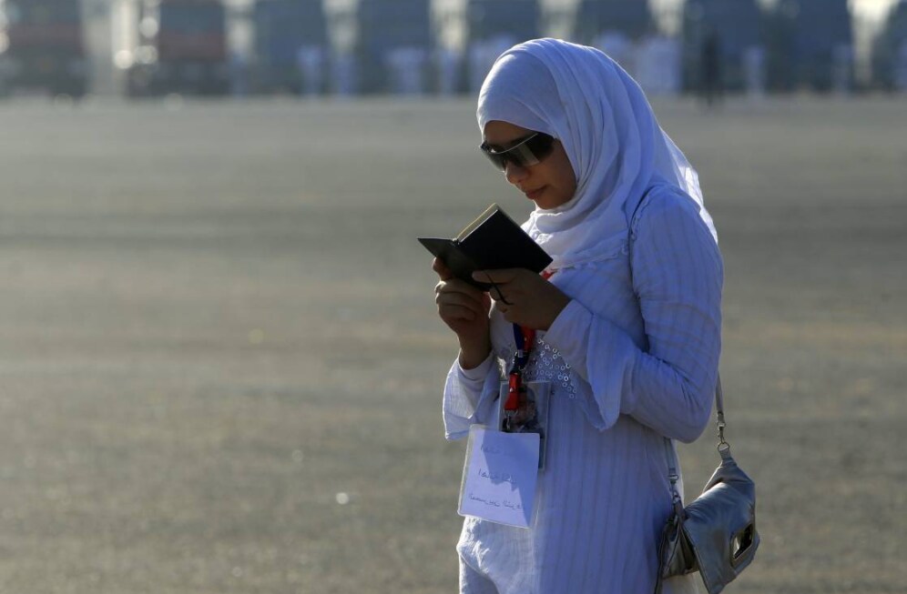a woman reads the Koran in Cairo