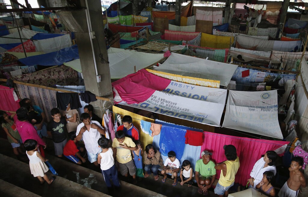 Residents who evacuated their homes due to flooding, in makeshift shelters on Mindanao