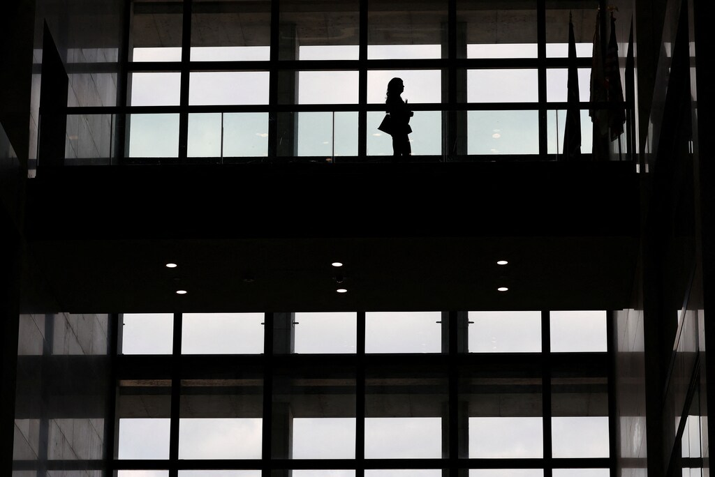 A person walks along a hallway in the glass atrium of the Hart Senate Office Building on Capitol Hill in Washington, U.S., December 18, 2024. REUTERS/Kevin Lamarque