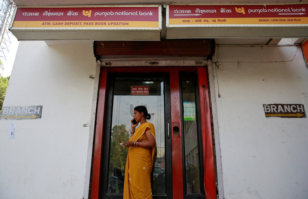 A woman speaks on her mobile phone outside a Punjab National Bank (PNB) branch in New Delhi, India, February 27, 2018. REUTERS/Saumya Khandelwal - RC12B3678870