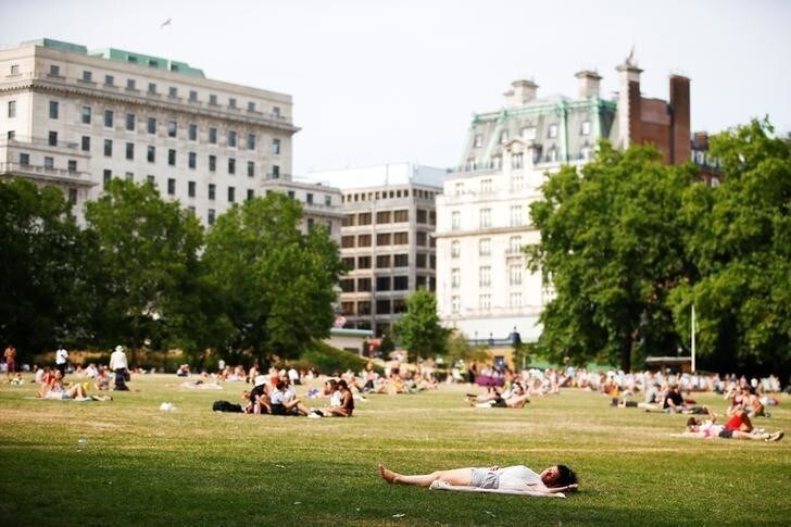 People relax in the sunshine at Green Park in London, Britain July 1, 2018. REUTERS/Henry Nicholls