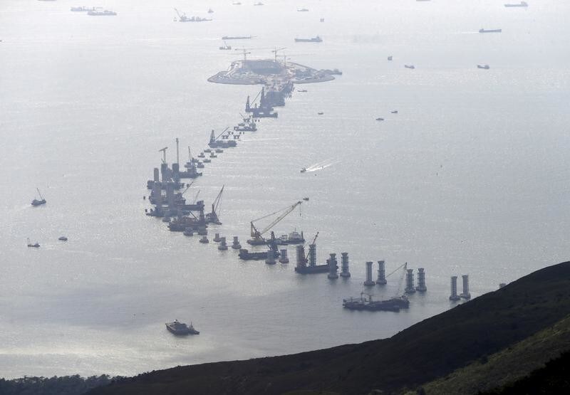 The Hong Kong-Zhuhai-Macao Bridge (HZMB), which will link the three cities in the Pearl River Delta, is seen under construction off Hong Kong's Lantau Island, China, June 12, 2015. HSBC is betting infrastructure construction in China's Pearl River Delta will turn the prosperous region of 40,000 square kilometres into a seamless metropolis that can fuel the bank's growth in the next decade. However, fundamental pieces of construction for the region are behind schedule. Hong Kong's transport minister said in January that a network of bridges and tunnels to link Hong Kong, Macau and the city of Zhuhai across the Pearl River Delta will not be finished by its 2016 target date amid rising costs. Picture taken June 12, 2015.