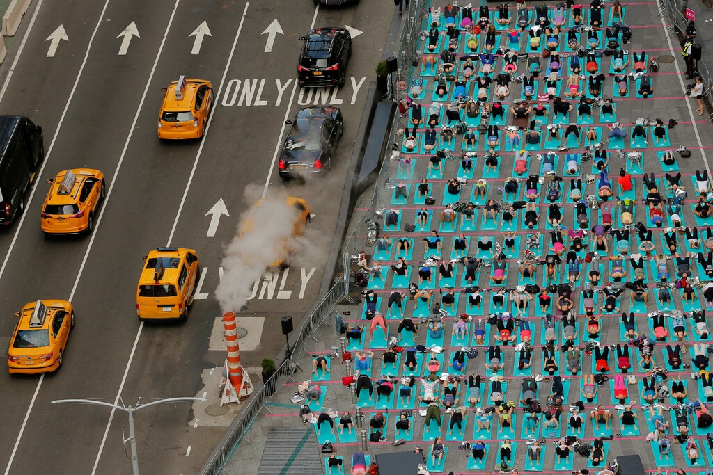 People participate in a yoga class during an annual Solstice event in the Times Square district of New York, U.S., June 21, 2017. REUTERS/Lucas Jackson TPX IMAGES OF THE DAY - RTS1816B