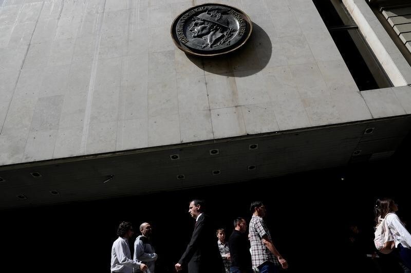 People walk past the entrance of the Buenos Aires Stock Exchange in Buenos Aires, Argentina September 26, 2018.