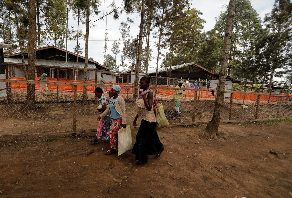 People walk past the Ebola treatment centre in Katwa, near Butembo, in the Democratic Republic of Congo, October 5, 2019. REUTERS/Zohra Bensemra - RC2FAD9HA1IT