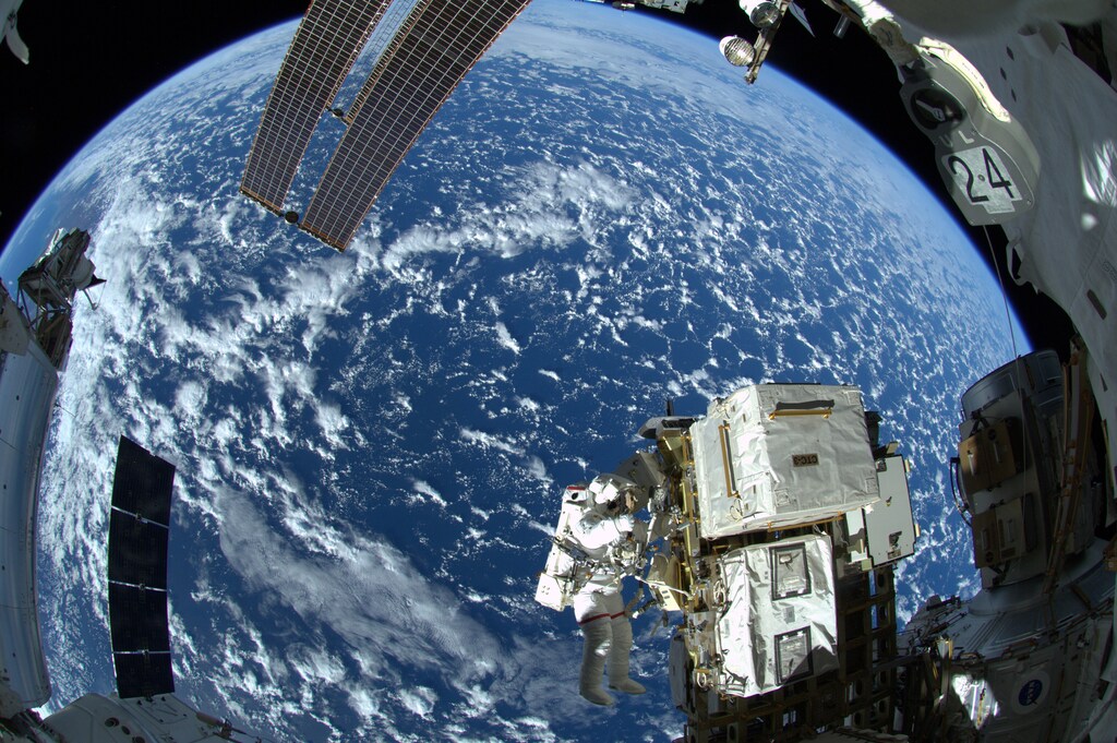 NASA astronaut Reid Wiseman and European Space Agency astronaut Alexander Gerst (not shown) works outside the space station's Quest airlock in the first of three spacewalks for the Expedition 41 crew aboard the International Space Station.