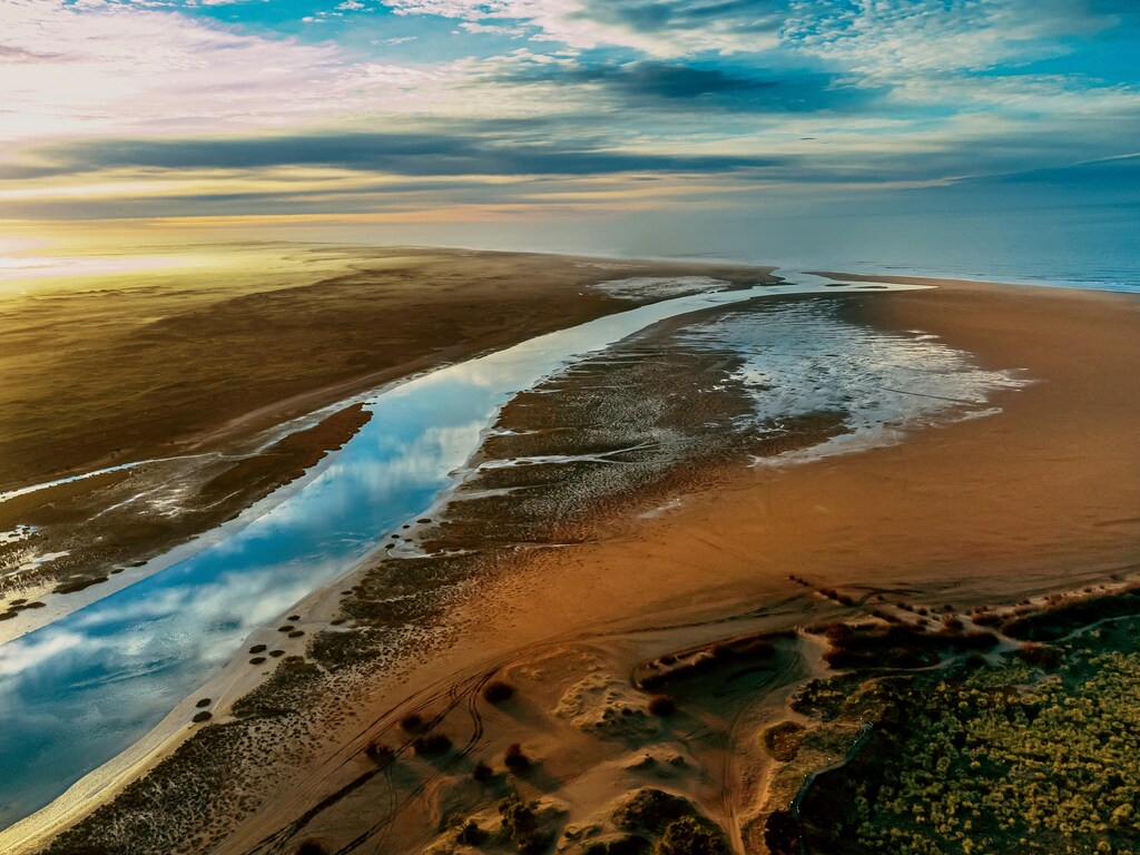 Aerial view of a river winding through a sandy landscape, illustrating the freshwater ecosystems central to the Blue Davos 2026 Year of Water initiative