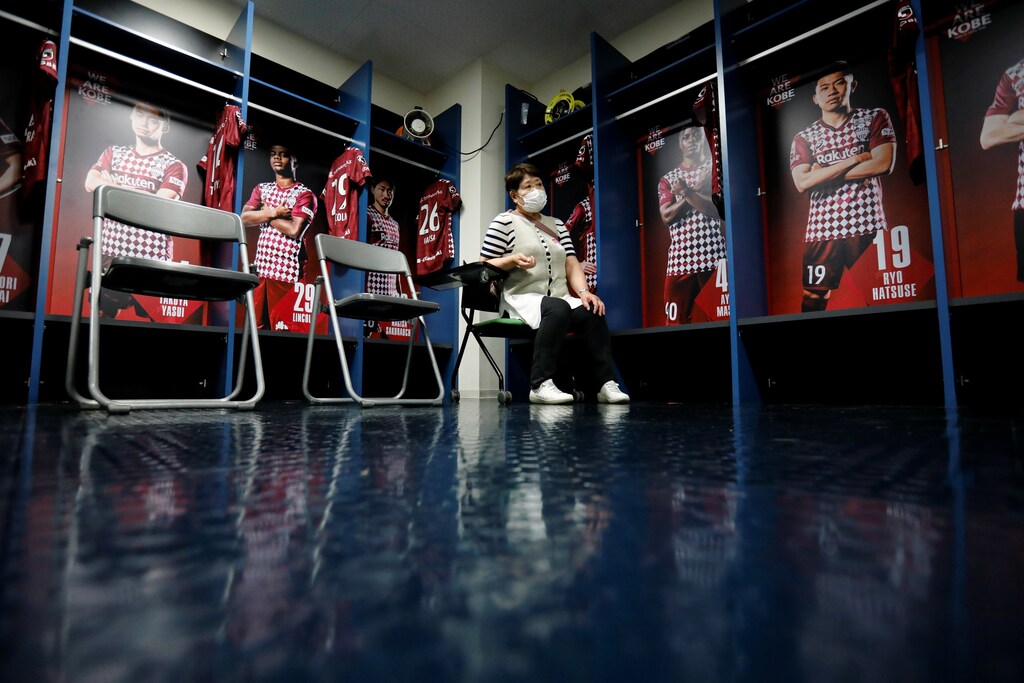 A woman waits for consultation after receiving a dose of the coronavirus disease (COVID-19) vaccine at the players' locker room of Japanese professional soccer club Vissel Kobe inside the Noevir Stadium Kobe, currently acting as a large-scale COVID-19 vaccination center, in Kobe, Japan June 12, 2021. REUTERS/Issei Kato - RC2QYN9IYCCO