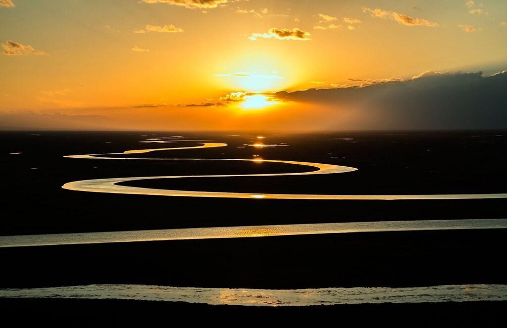 Curving river at sunset