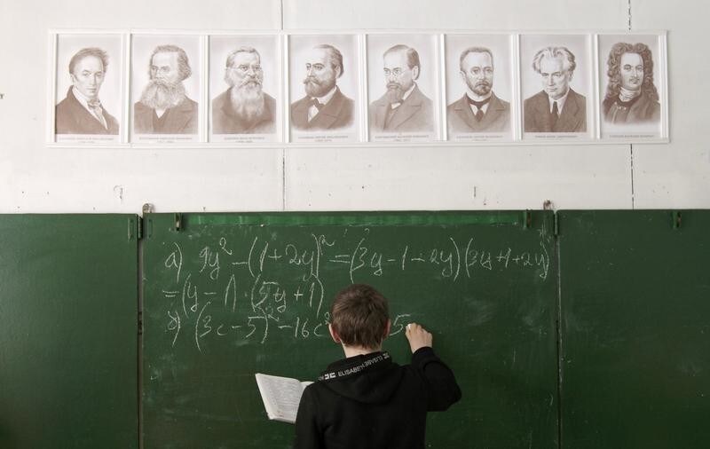 Andrey Marchenkov, 13 writes on the blackboard as he attends a mathematics lesson at a local school based in the remote Russian village of Bolshie Khutora, about 440 km (273 miles) west of Moscow, March 14, 2012. The school, well-known in the region for only 12 pupils studying here, is situated in the village, population of which decreases each year. Nevertheless the school authorities and teachers are proud of the high level of education given to the few students who are treated individually and carefully here. Pupils, many of whom are winners of numerous local educational contests, like studying and exploring ecology, according to school representatives. REUTERS/Vasily Fedosenko (RUSSIA - Tags: EDUCATION TPX IMAGES OF THE DAY) - GM1E83E1TPZ01