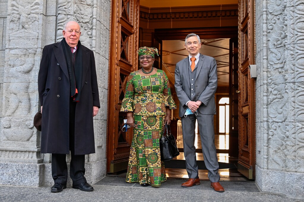 image of new Director-General of the World Trade Organization Ngozi Okonjo-Iweala poses between WTO Deputy Directors-General Alan Wolff (L) and Karl Brauner upon her arrival at the WTO headquarters to take an office in Geneva, Switzerland