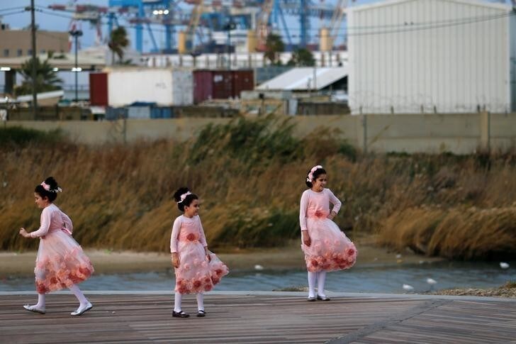 Ultra-Orthodox Jewish girls pose for a photographer near the beach in the southern city of Ashdod December 13, 2016. REUTERS/Amir Cohen