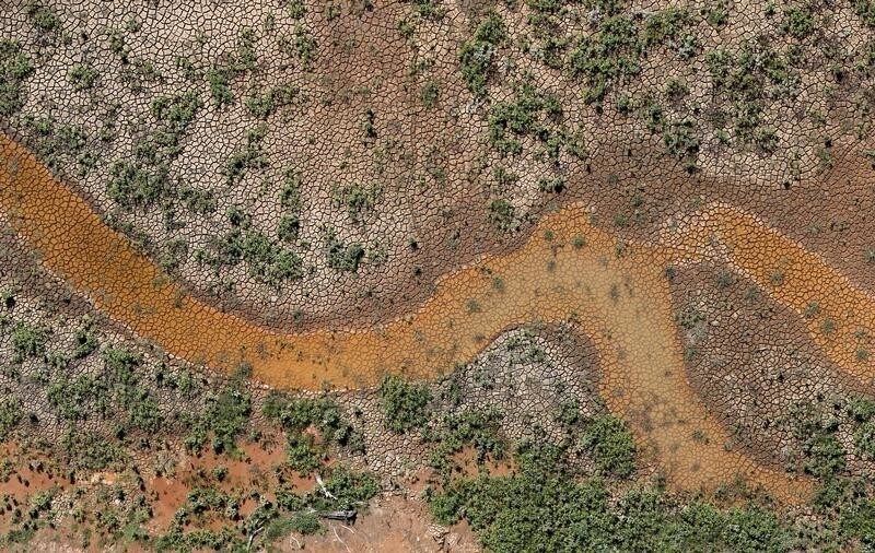 An aerial view of the cracked ground of the Atibainha dam, part of the Cantareira reservoir, is seen during a drought in Nazare Paulista, Sao Paulo state February 12, 2015. Brazil's worst drought in 80 years has left the Cantareira system, that provides greater Sao Paulo with most of its water, with the lowest water level on record. Brazil's economy is already expected to post zero growth this year. Worse yet, since Brazil depends on hydroelectric dams for about three quarters of its electricity, power shortages are also possible due to the drought, federal officials have said. REUTERS/Paulo Whitaker (BRAZIL - Tags: ENVIRONMENT DISASTER TPX IMAGES OF THE DAY) - GM1EB2D0USC01