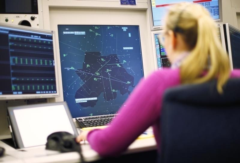 An operator of Swiss air traffic control firm Skyguide monitors airplanes at the Skyguide monitoring centre in Duebendorf, near Zurich, April 3, 2013. Skyguide held its annual news conference today. REUTERS/Michael Buholzer (SWITZERLAND - Tags: TRANSPORT BUSINESS) - RTXY6RQ