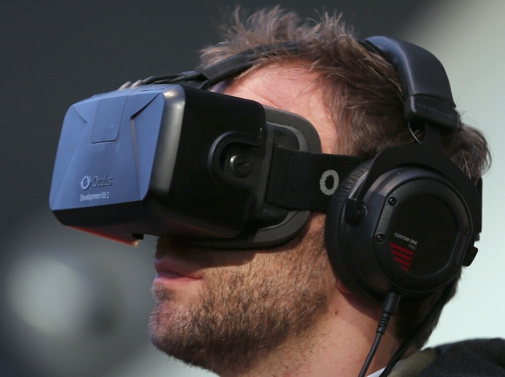A man trys out 3D goggles at the Vodafone stand at the CeBit trade fair in Hanover March 16, 2015. The world's biggest computer and software fair will open to the public from March 16 to 20. REUTERS/Morris Mac Matzen (GERMANY - Tags: BUSINESS SCIENCE TECHNOLOGY POLITICS) - RTR4TJ0M