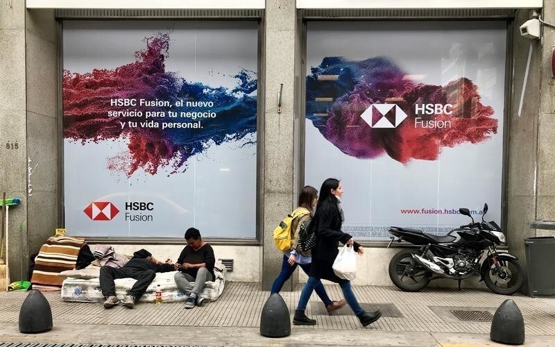 A homeless woman and a man rest on a mattress outside a bank in Buenos Aires' financial district, Argentina September 27, 2018.