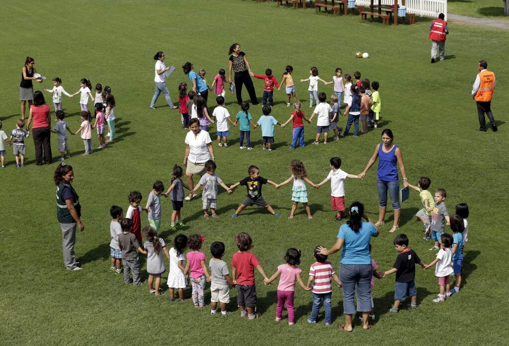 Students stand in circles during a national earthquake evacuation drill at Franco Peruano school in Lima April 22, 2015. The Ministry of Education of Peru conducted a nationwide earthquake and landslides drill to raise awareness of proper evacuation plans and prepare students in case of a disaster, according to local media. REUTERS/Mariana Bazo - GF10000068924