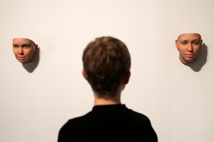 Artist Heather Dewey-Hagborg looks at 3-D printed masks she created from DNA extracted from cheek swabs and hair clippings she received from formerly imprisoned U.S. Army Private Chelsea Manning while she was in jail, ahead of the August 2, 2017 opening of "A Becoming Resemblance", an exhibition at the Fridman gallery in New York City, July 7, 2017. REUTERS/Mike Segar