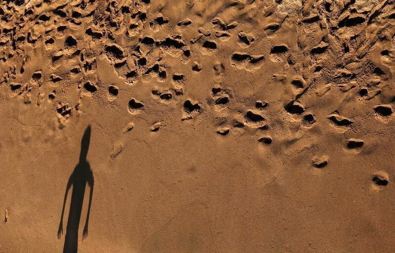 The shadow of a child is cast on a beach in the city of Vina del Mar, Chile July 14, 2019. REUTERS/Rodrigo Garrido - RC141480C280