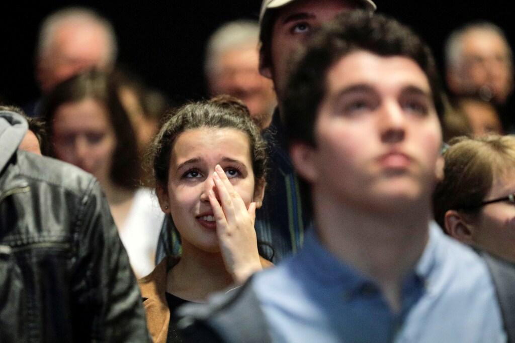 French university student and Jean-Luc Melenchon supporter Clara Lamotte reacts as she watches the televised French presidential elections at a viewing event held by the Universite de Montreal in Montreal, Quebec, Canada, April 23, 2017. REUTERS/Dario Ayala - RTS13KUK