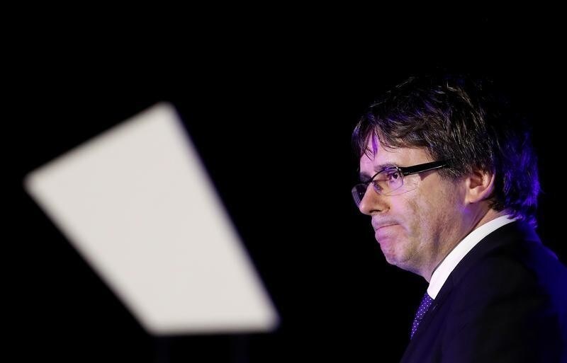 Catalan President Carles Puigdemont leaves the stage after addressing the crowd of people attending a closing rally in favour of the banned October 1 independence referendum in Barcelona, Spain, September 29, 2017. REUTERS/Yves Herman - RC15E5B48240