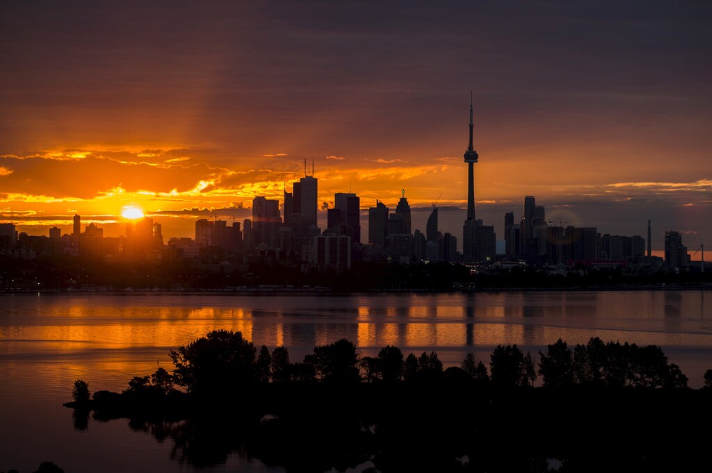 The sun rises over the skyline in Toronto, August 4, 2015.
