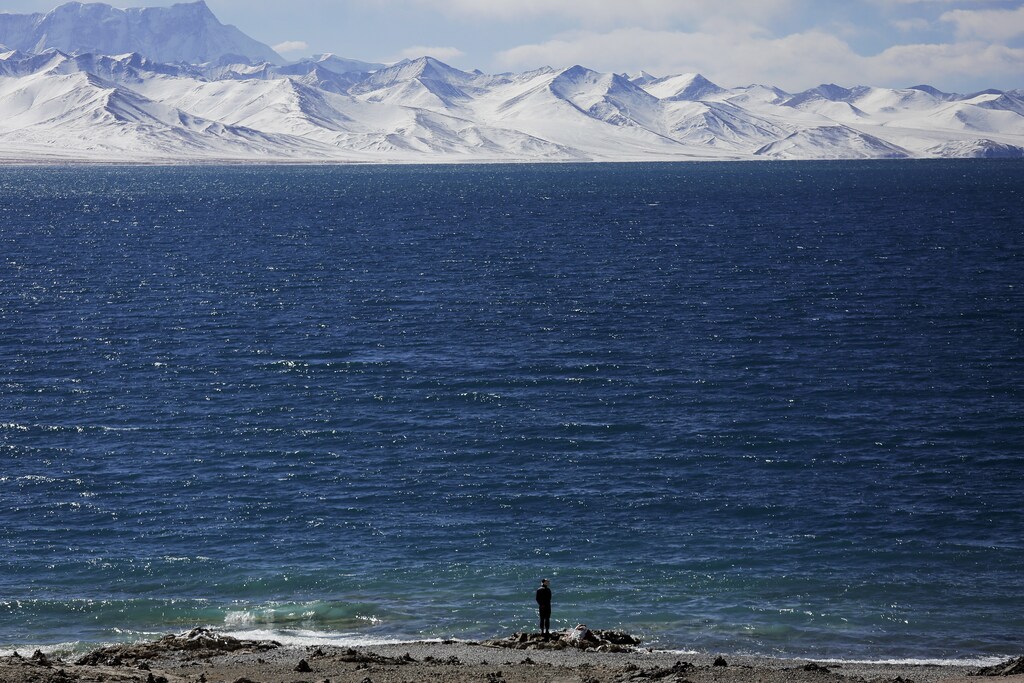 A Tibetan man stands at shores of Namtso lake in the Tibet Autonomous Region, China November 18, 2015. Located four hours' drive from Lhasa at an altitude of around 4,718m (15,479 ft) above sea level, Namtso lake is not only the highest saltwater lake in the world but also considered sacred, attracting throngs of devotees and pilgrims. REUTERS/Damir Sagolj TPX IMAGES OF THE DAY - GF20000064821