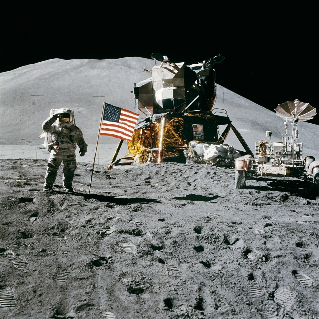 a picture of the moon landing - with the lunar module, american flag and James Irwin saluting during the Apollo 15 mission.