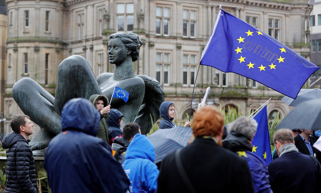 Protesters wave Europen Union flags during an anti-Brexit demonstration after Britain's Prime Minister Theresa May triggered the process by which the United Kingdom will leave the Euopean Union, in Birmingham, Britain March 29, 2017. REUTERS/Darren Staples - RTX3394O