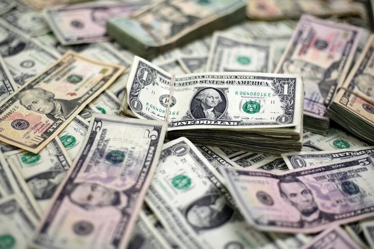 U.S. Dollar banknotes are seen in this photo illustration taken February 12, 2018. REUTERS/Jose Luis Gonzalez/Illustration