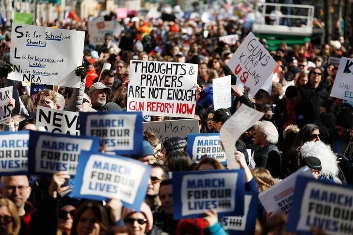 Protesters raise signs during a "March For Our Lives" demonstration demanding gun control in New York City, U.S. March 24, 2018. REUTERS/Shannon Stapleton