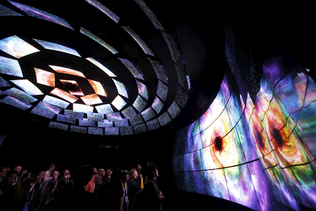 Attendees watch a display of 4K OLED televisions at the LG Electronics booth during the 2016 CES trade show in Las Vegas, Nevada January 7, 2016.