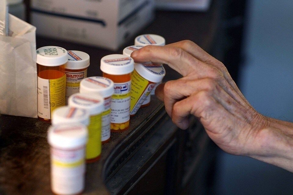 MIAMI - FEBRUARY 25: Robert Granville reaches for a medicine bottle as he takes his prescription pills on February 25, 2009 in Miami, Florida. Because of budget constraints and a high level of need, Robert is on a one-year waiting list for home care, which many elderly advocates fear may be even longer if funding is cut for these programs due to the economic meltdown. Robert can barely get around his house due to lower back problems and weak legs and found himself in need after falling recently while working outside his house. He spent two days laying on the ground. (Photo by Joe Raedle/Getty Images) *** Local Caption *** Robert Granville