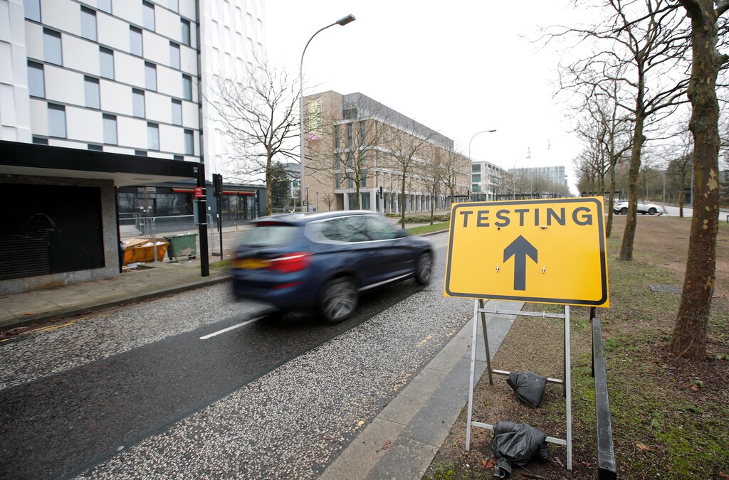 A car drives past a sign directing to the testing centre amid the outbreak of the coronavirus disease (COVID-19) in Milton Keynes, Britain, January 1, 2021. REUTERS/Andrew Boyers - RC24ZK9LFMFJ
