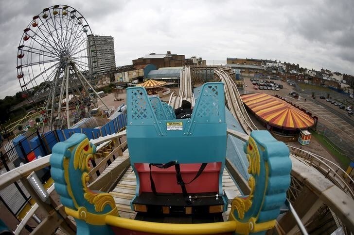 Locals ride the Scenic Railway rollercoaster during a media preview at Dreamland in Margate, Britain, October 15, 2015. Britain's oldest rollercoaster Scenic Railway reopens for public on Friday. REUTERS/Stefan Wermuth