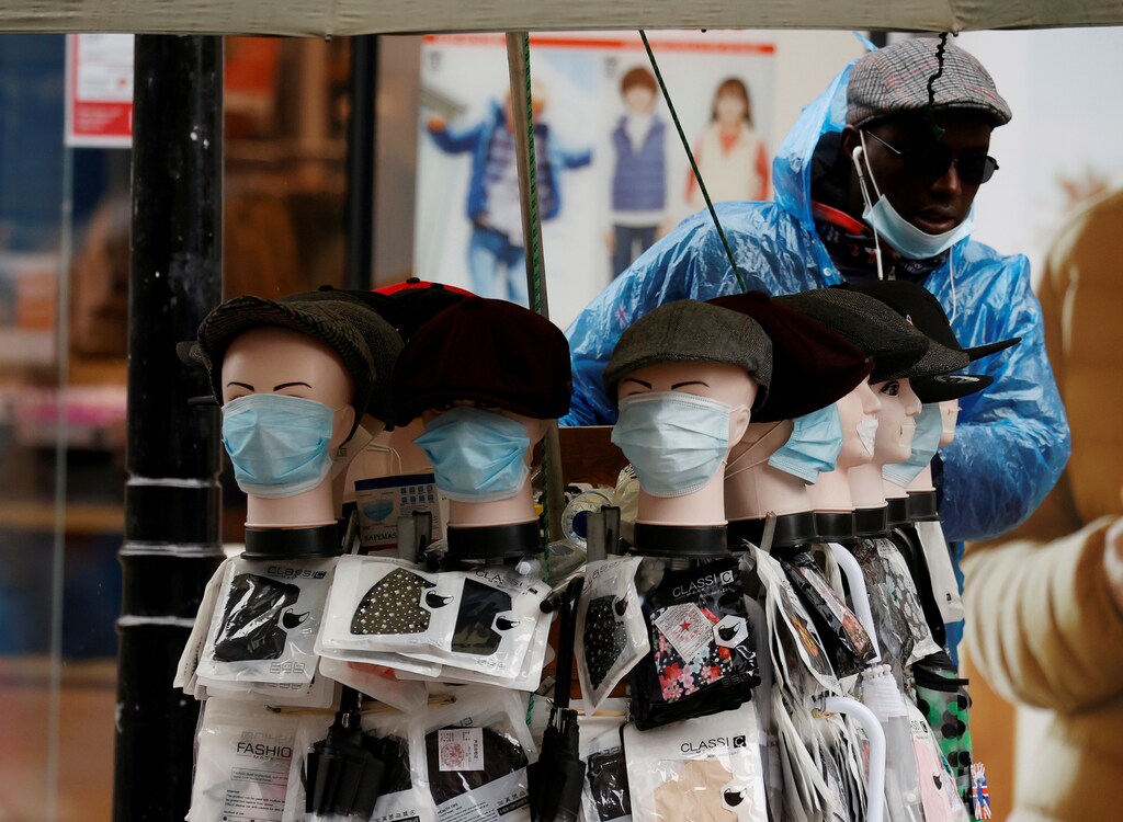 A street trader sells face masks from a stall following the outbreak of the coronavirus disease (COVID-19) in Manchester, Britain, October 5, 2020. REUTERS/Phil Noble TPX IMAGES OF THE DAY - RC2ECJ9912Q6