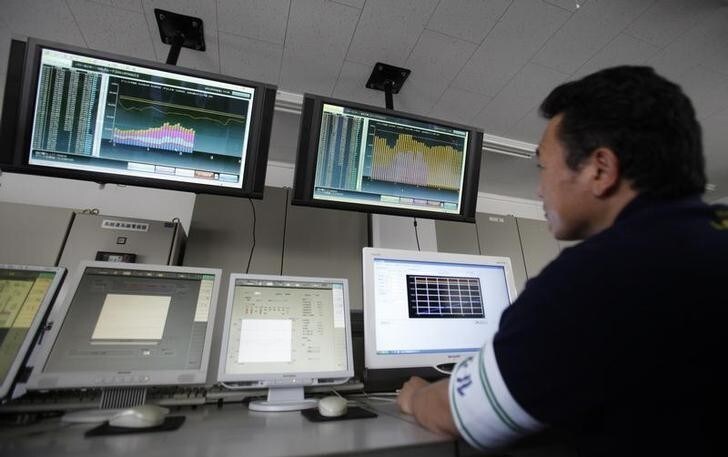 An employee of Nissan Motor Co monitors real-time power usage data at the company's facilities at the Oppama plant in Yokosuka, south of Tokyo July 2, 2011. With 35 of Japan's 54 nuclear power plants shut, the Japanese government has ordered big companies to cut their peak power consumption by 15 percent from last year this summer, in the first such mandate since the oil crisis of 1974. To meet the target, the auto industry has changed its weekend holidays to Thursdays and Fridays between July and September. REUTERS/Yuriko Nakao (JAPAN - Tags: TRANSPORT ENERGY)