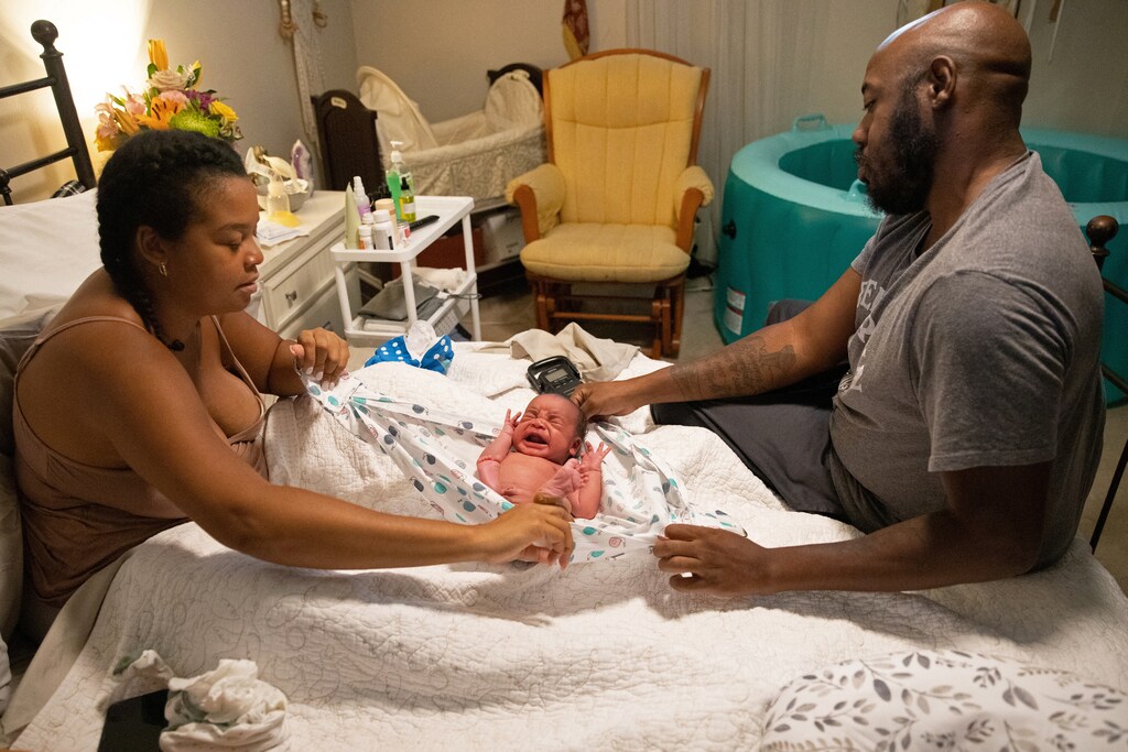 Holistic doula Ciara Clark, 34, and her husband Anthony Clark, a 38-year-old VIP associate for a sports betting company, prepare Evan, their crying newborn, to be weighed in Toms River, New Jersey, U.S., September 18, 2023. With her own Black doula and mother by her side, Clark had hoped to have her baby at home with no medical assistance at all. She wanted to have a "wild" pregnancy - one that is medically unassisted. After four cesarean sections with her previous pregnancies, Clark said she feared that her birth plan would not be supported by the medical staff. But after a long labor, Clark said she became anxious and decided to go to the hospital, where she gave birth to a healthy son. Clark is not alone in her distrust of medical intervention in the birthing process. Nine Black pregnant women and new mothers Reuters spoke to for this story voiced similar comments. All of the women spoke of feeling unseen and unheard at times through their pregnancy and postpartum period. REUTERS/Joy Malone SEARCH "MALONE MOTHERS DAY" FOR THIS STORY. SEARCH "WIDER IMAGE" FOR ALL STORIES. healthcare