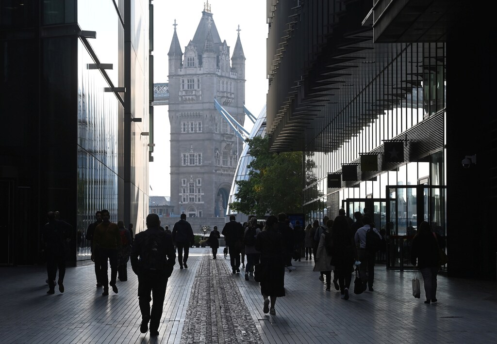 Workers walk towards Tower Bridge during the morning rush hour, amid a relaxation of lockdown restrictions during the coronavirus disease (COVID-19) pandemic in London, Britain, September 15, 2021. REUTERS/Toby Melville - RC28QP9J1265