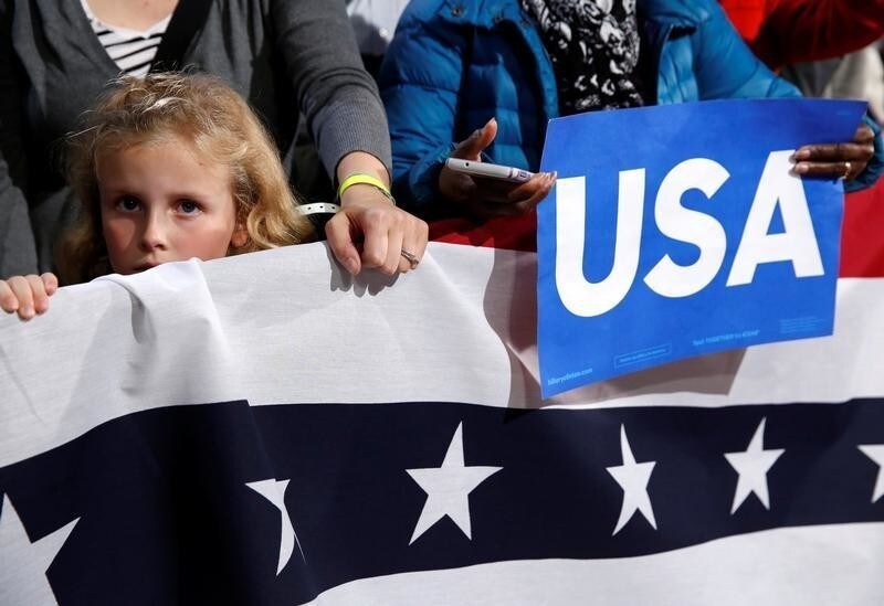 A young girl listens as U.S. President Barack Obama campaigns for Democratic presidential nominee Hillary Clinton at the University of New Hampshire in Durham, New Hampshire, U.S., November 7, 2016. REUTERS/Kevin Lamarque - S1AEULNTRFAA