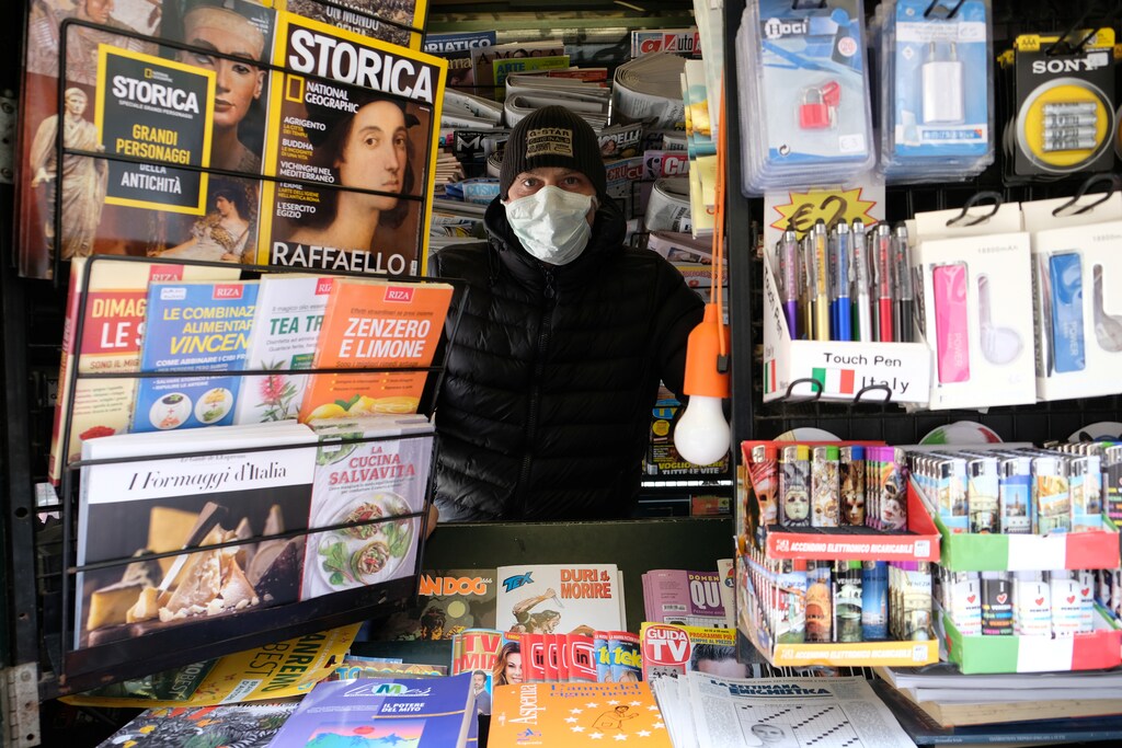 Newspapers stand worker wearing a proctective mask is seen after Italy tightened the lockdown measures to combat the coronavirus disease (COVID-19) outbreak in Venice, Italy, March 22, 2020. REUTERS/Manuel Silvestri - RC21PF9178EE