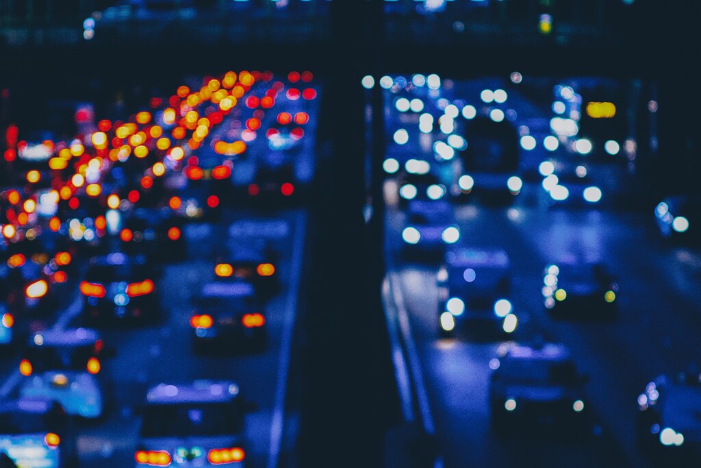 A city street filled with lots of traffic at night, blurry: Road traffic fatalities stand at an annual 1.3 million, with 50 million people injured yearly.