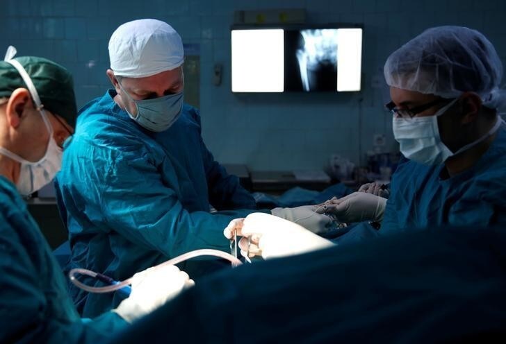 Meho Kovacevic (C), a 43-year-old orthopedic surgeon, participates in a surgical operation in Zenica, Bosnia and Herzegovina March 18, 2015. Picture taken March 18, 2015. REUTERS/Dado Ruvic